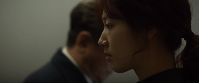 Korean woman whispers in ear